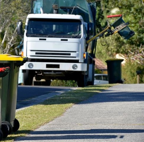 Government fleet garbage truck on road Government fleet garbage truck on road