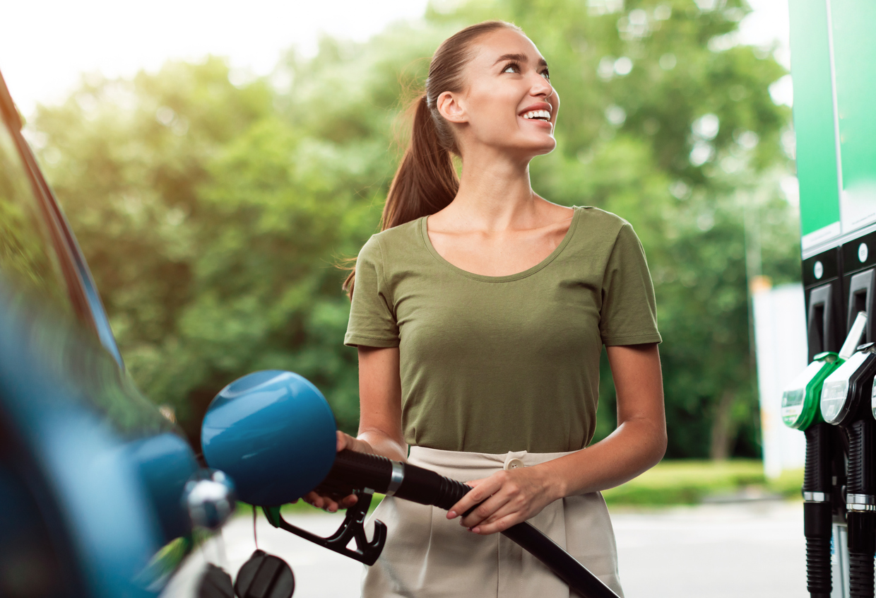 Smiling Lady Refilling Automobile With Fuel At Modern Petrol Station Standing Near Vehicle Outside
