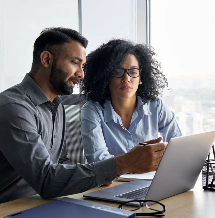 man-and-woman-looking-at-laptop-and-discussing-in-office