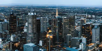 Aerial night view of city skyline with illuminated buildings and streets