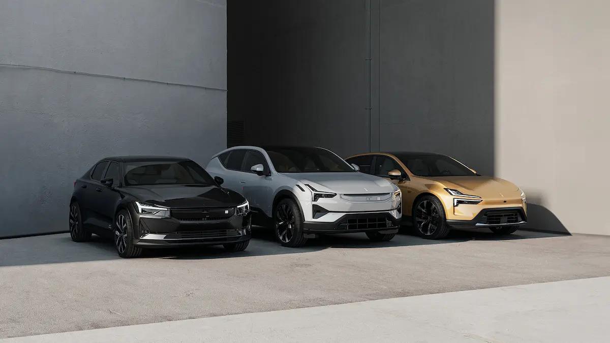 Three EV cars parked side by side against a modern building.