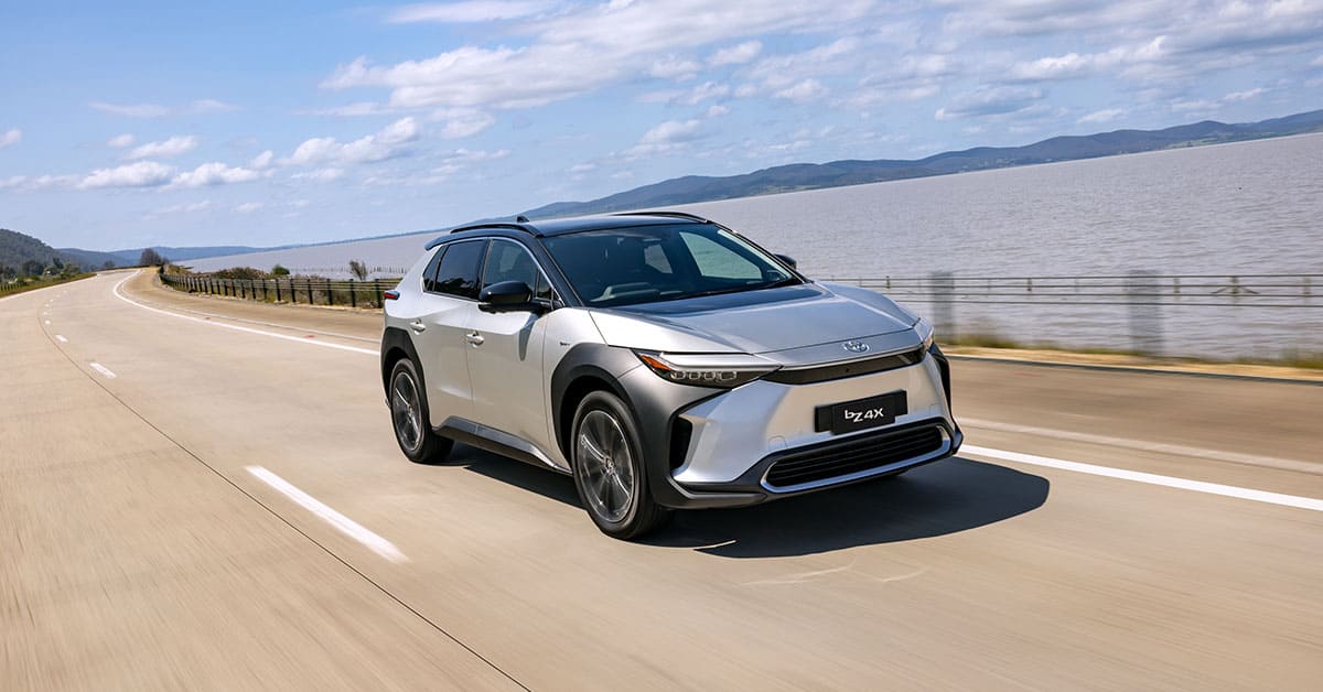 A 2021 Toyota HR-V driving along a scenic highway, showcasing its sleek design and dynamic performance.