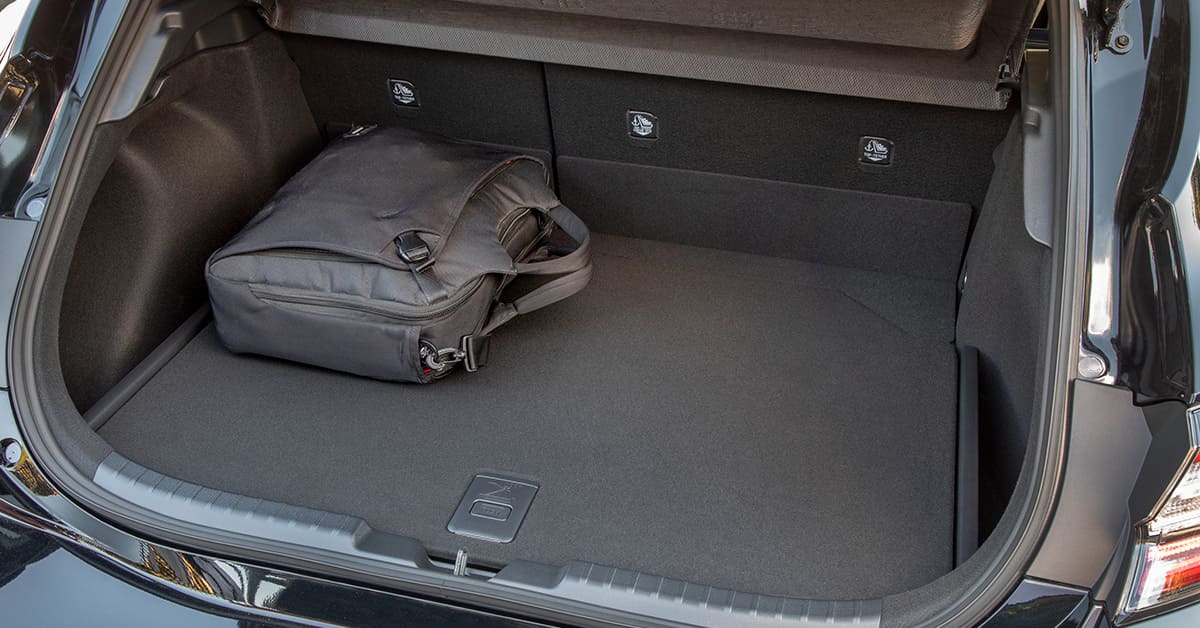 A car trunk open with a bag placed inside, showcasing the storage space and organization of the vehicle.