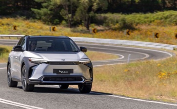 A new Toyota Mirai drives along a scenic road, showcasing its sleek design and advanced technology. globalblog'