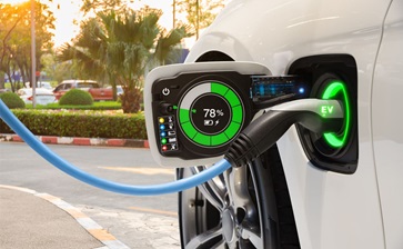 A sleek electric vehicle driving on a futuristic road, showcasing advanced technology and sustainable energy solutions. globalblog'