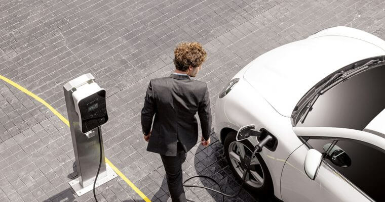 All you need to know- THUMBNAIL Man charging white EV
