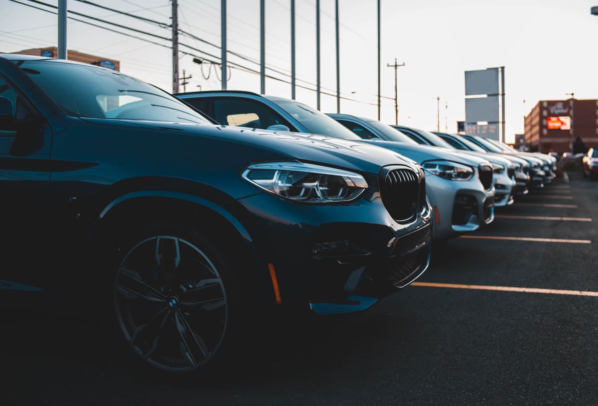 BMW X3 parked in a lot, showcasing its sleek design and modern features under clear blue skies.