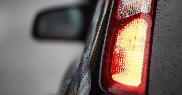 Close-up view of a car's tail light, showcasing its design and illumination features.