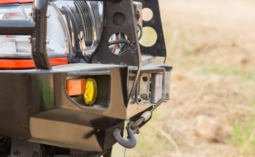 Close-up view of a red Jeep's front bumper, showcasing its rugged design and vibrant color. globalblog'
