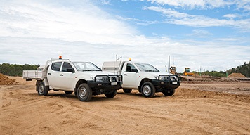 corporate-trucks-white-parked-sandy-ground