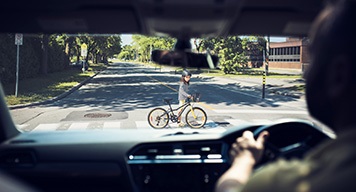 Man-Driving-Car-Watching-Kids-Crossing-Road-Bike Man-Driving-Car-Watching-Kids-Crossing-Road-Bike