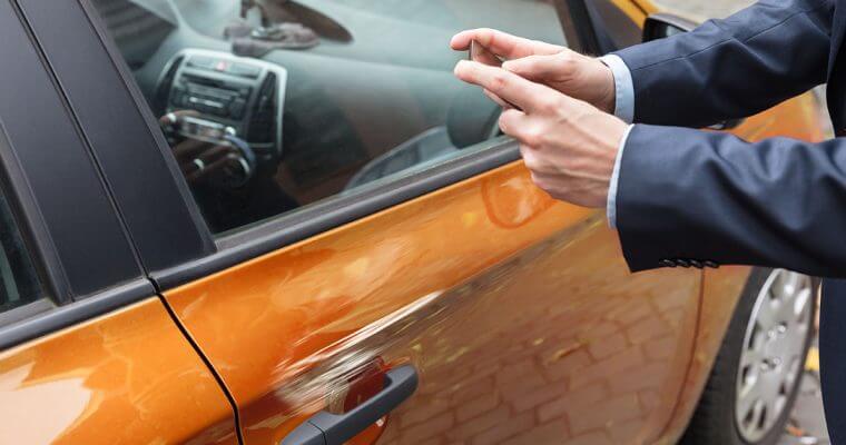 Managing fleets- man taking photo of vehicle Man taking photo of vehicle