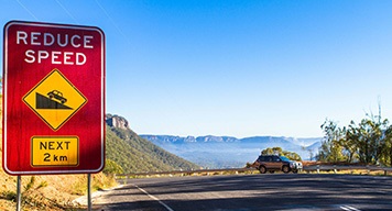 red-reduce-speed-sign-blue-mountain-traffic-safety red-reduce-speed-sign-blue-mountain-traffic-safety