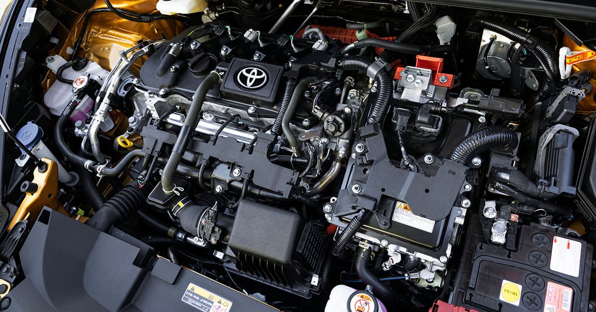 The image displays the engine compartment of a car, showcasing various components and machinery within.