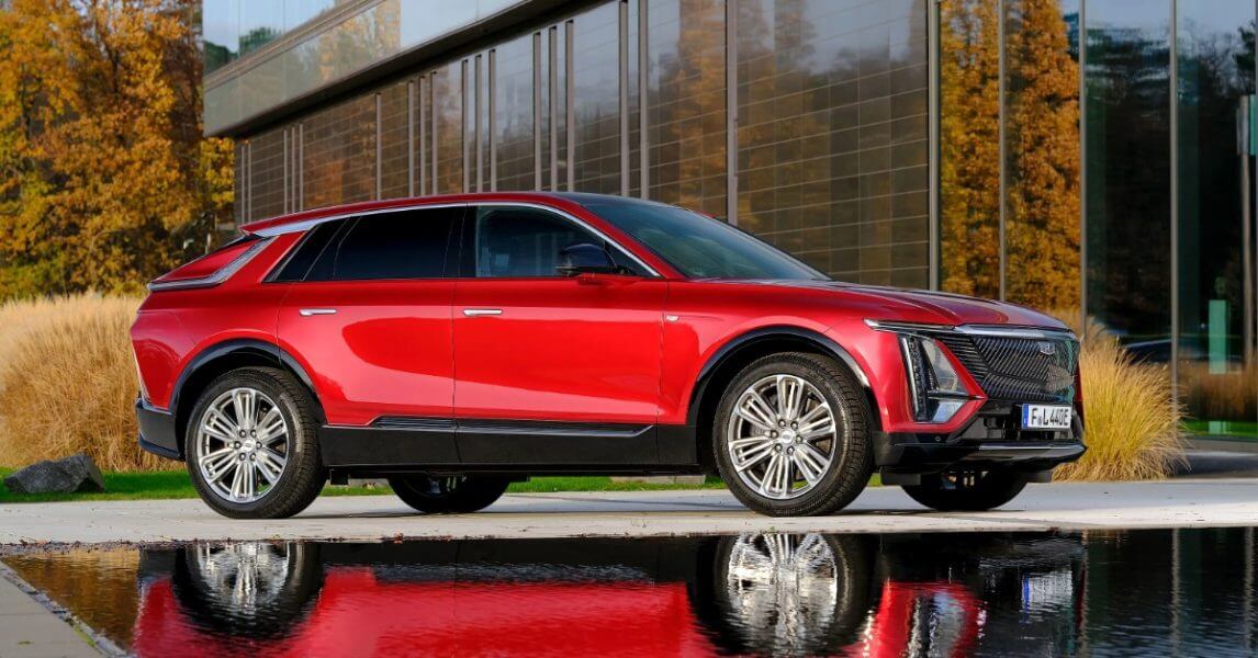Vehicles coming to australia- red car in front of house