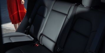 Woman getting into a vehicle back seat. Seats are pristine from Oridon Interior Surface Coating.