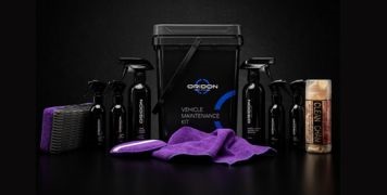 Collection of items included in Oridon Vehicle Maintenance Kit. Pictured are spray bottles, sponges, cloths, and storage bucket.