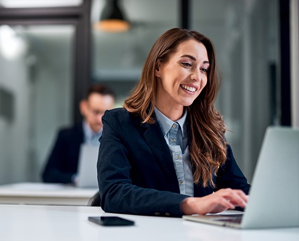 A-cheerful-adult-ambitious-businesswoman-working-over-a-laptop-and-sitting-at-the-office-with-a-male-colleague A-cheerful-adult-ambitious-businesswoman-working-over-a-laptop-and-sitting-at-the-office-with-a-male-colleague
