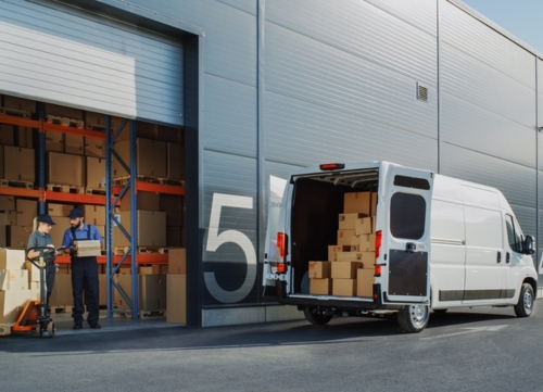 A fleet procurement van loading from a warehouse