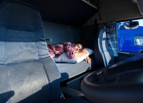 A long distance driver asleep in his cab