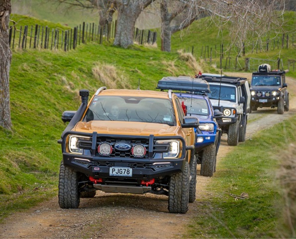Line up of vehicles on New Zealand rural road with ARB fitouts