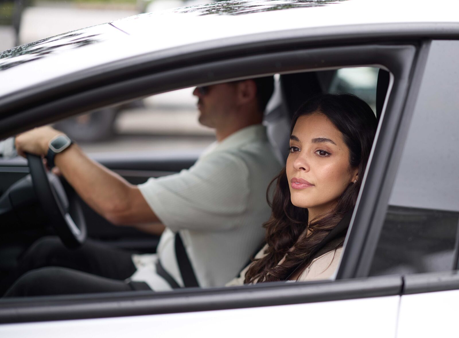 EV_Day_Couple_Driving_3-medium Two people driving in a vehicle