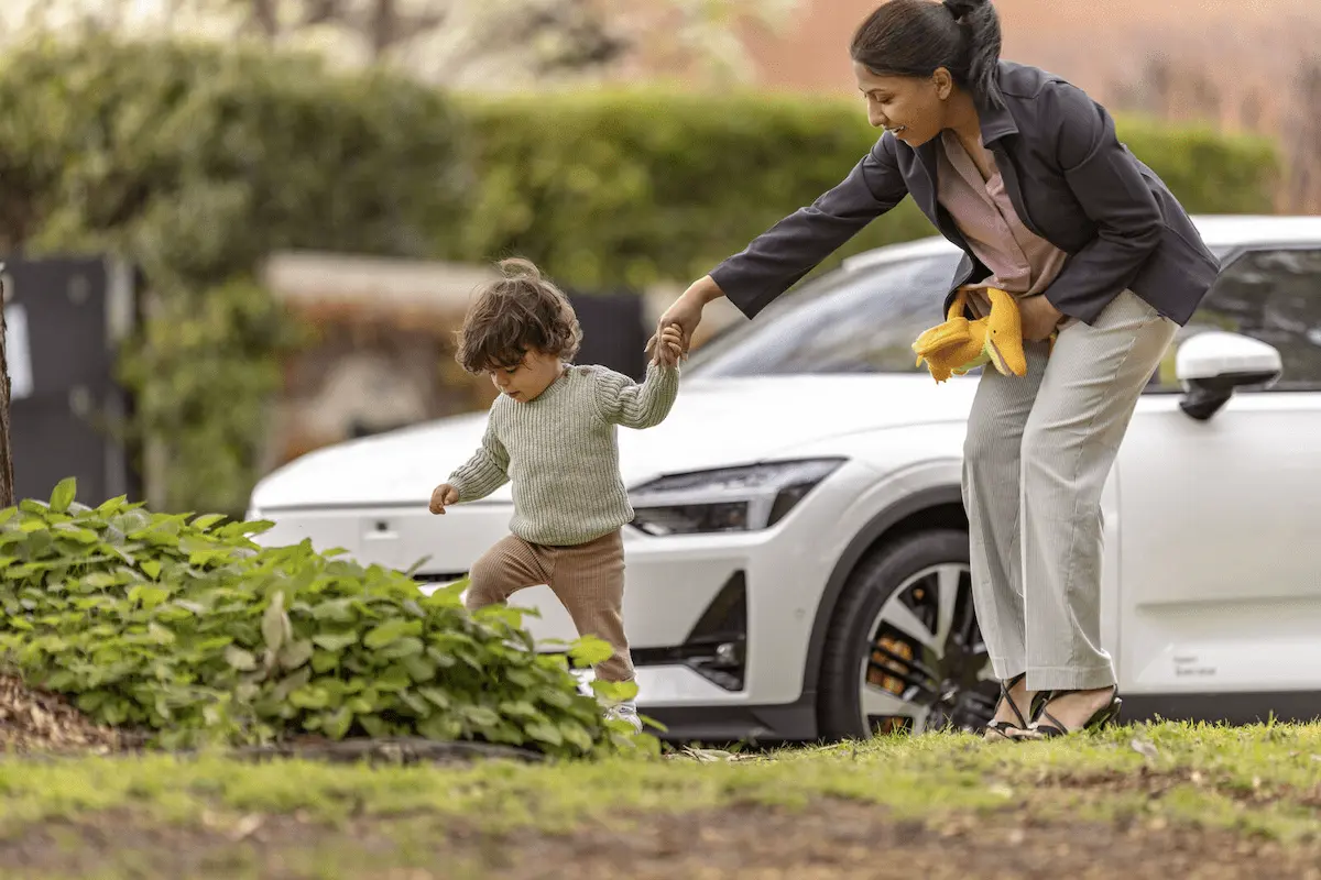 Woman with small child walking alongside the road