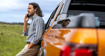man standing next to ute