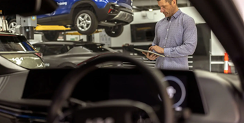Mechanic reviewing tablet for vehicle service