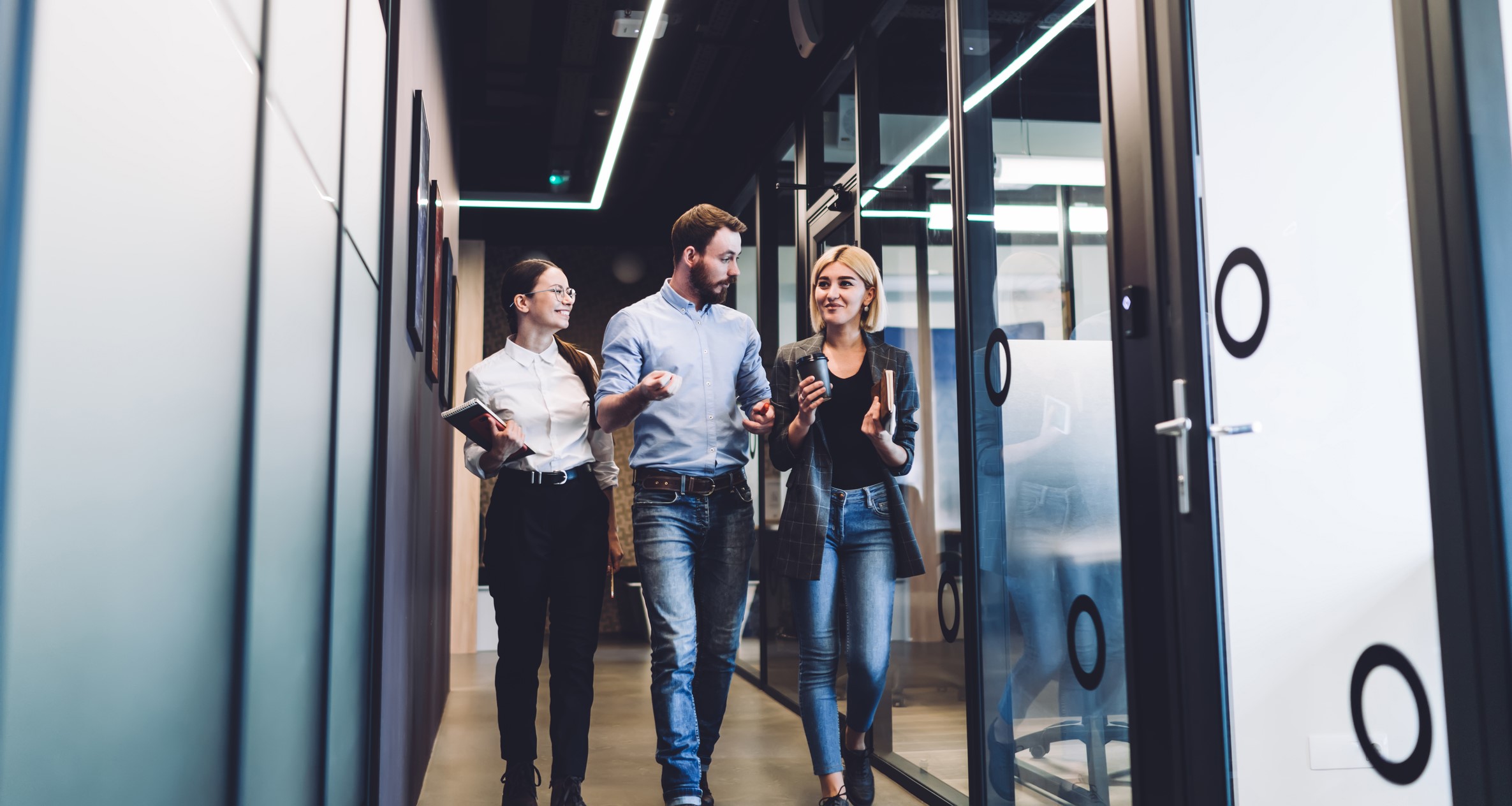 professionals-walking-through-office