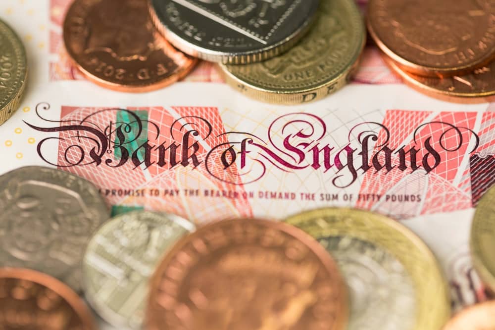 BoE rate changes vehicle leasing Close-up of Bank of England note with British coins