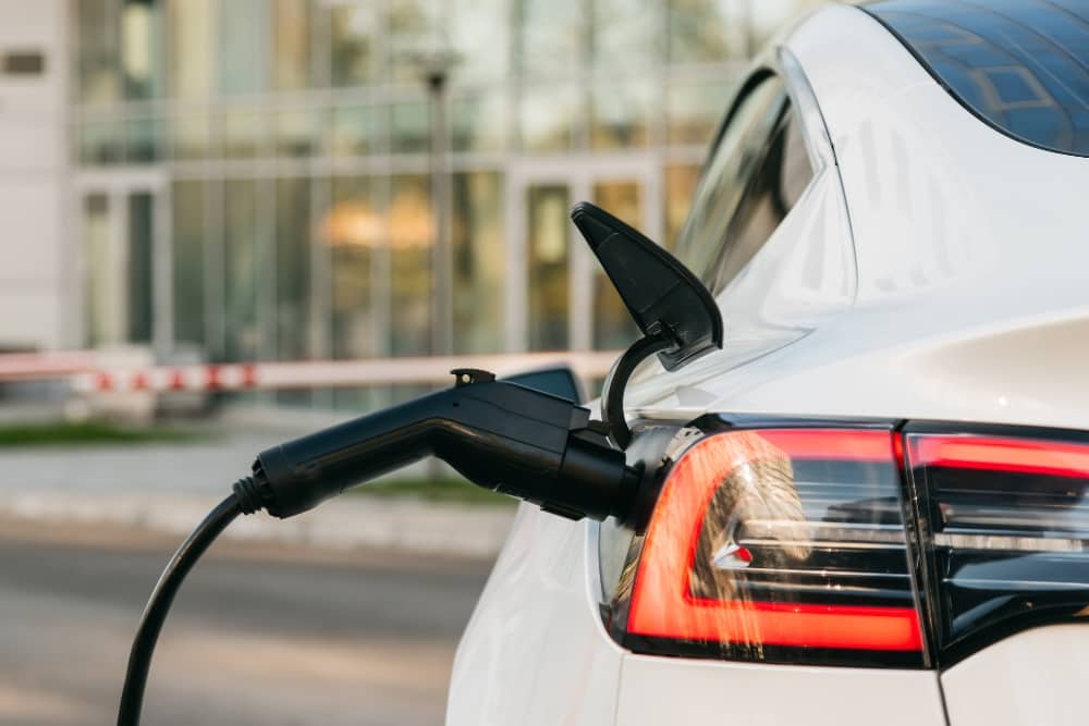 Close-up of electric car charging at station