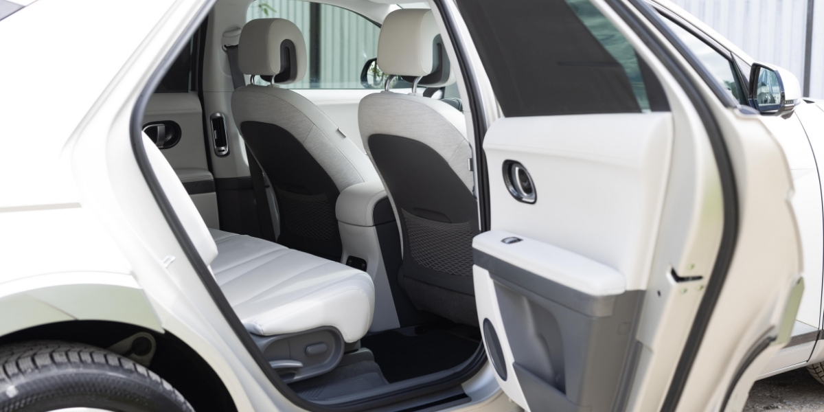 Rear passenger doors open to show the interior seating of a modern electric SUV