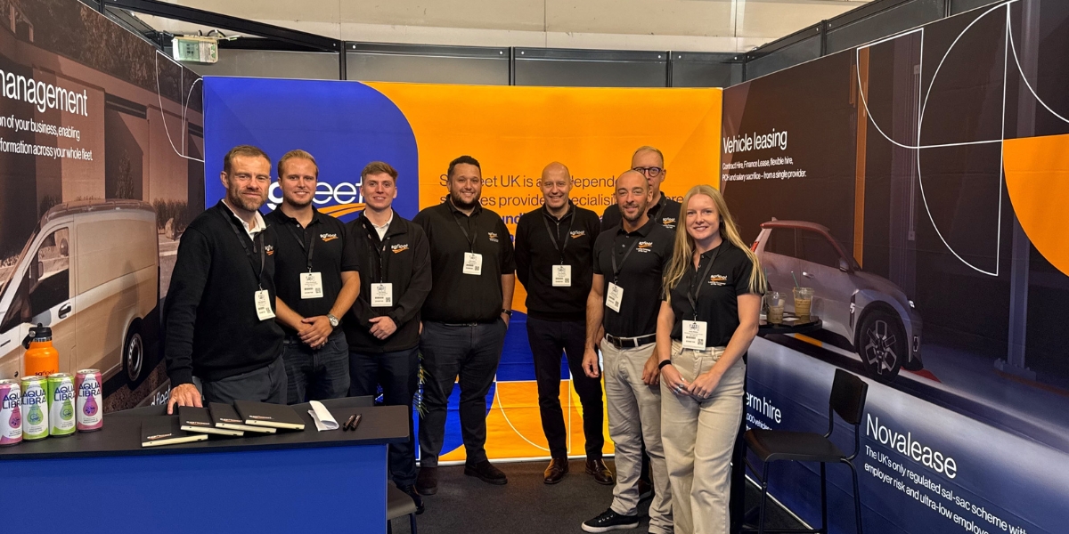 sg fleet fleetlive: SG Fleet UK team on their exhibition stand at Fleet & Mobility Live 2026, with Novalease and vehicle leasing displays behind them